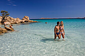 Couple at Spiaggia Capriccioli, Costa Smeralda, Sardinia, Italy