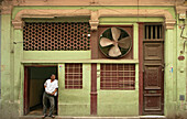 Junger Kubaner im Eingang einer Werkstatt in Havanna's Altstadt