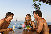 People with cocktails in beach bar