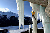 Male ice climber ascending ice, Curtain Call, British Columbia, Canada