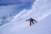 Snowboarding on mountain slope, Kuehtai, Tyrol, Austria