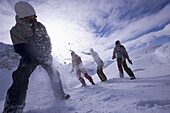 Young people having fun with snowball fight, Kuehtai, Tyrol, Austria