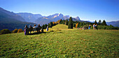 Hiker sitting on bench, Graseck, View to Wetterstein and Zugspitze, Alpspitze, Upper Bavaria, Germany, Alpspitze