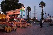 People sitting in an open-air restaurant at Harbour Promenade, Kos-Town, Kos, Greece