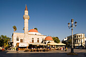 View over the Platia Eleftherias to a pavement cafe at Defterdar-Mosque, Kos-Town, Kos, Greece