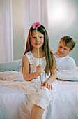 Girl with Gerbera on bed with father, portrait