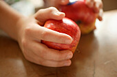 Hands holding red apples