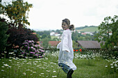 Girl running in garden