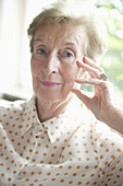 Senior Woman with hand on head, portrait