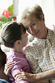 Großmutter umarmt ihre Enkelin, close up