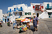 Woman passing a typical souvenir shop, Mykonos-Town, Mykonos, Greece