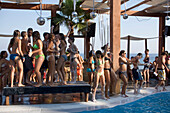 Young people dancing during a beach party at a pool of the Paradise Club, Paradise Beach, Mykonos, Greece
