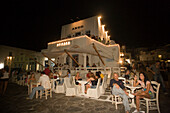 People sitting in open-air area of Argo Bar near harbour, Mykonos-Town, Mykonos, Greece