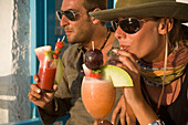 Couple enjoying the cocktail Sundowner in the Caprice Bar, Little Venice, Mykonos-Town, Mykonos, Greece
