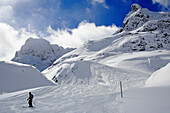 A skier on the ski slopes of Lech Zuers am Arlberg. Lech Zuers, Zürs, Arlberg, Austria, Alps, Europe.