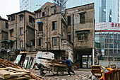 Abriss, demolition in old town, Lao Xi Men,Migrant worker, Abriss, Wanderarbeiter, redevelopment area, Abrissgebiet, living amongst demolished  houses, slum