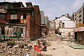 demolition in old town, Lao Xi Men,redevelopment area, living amongst demolished houses, slum, Living amongst ruins, encroaching new highrise