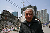 demolition in old town, Lao Xi Men,Old lady, one of the last residents of a demolished quarter, refusing resettlement, redevelopment area, living amongst demolished houses, slum