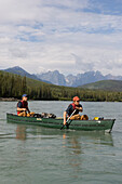 Two men in a canoe on South Nahanni River with Cirque of the Unclimbables in the background, Northwest-Territories, Canada