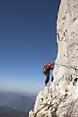 Young female climber on the Donnerkogel fixed rope route, Gosaukamm, Dachstein Mountain, Austria