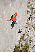 Man climbing up a rock face, Raetikon, Austria