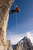 Climber abseiling from Raetikon Mountain, Switzerland