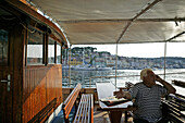 Captain on the phone, excursion boat, Mali Losinj Harbour, Cres Island, Croatia