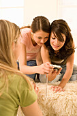 Teenage girls (14-16) looking at image on digital camera