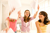 Teenage girls (14-16) throwing papers through the room