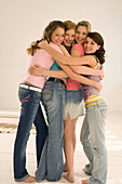 Four teenage girls (14-16) with arms around each other, smiling