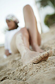 Young woman lying on the beach