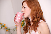 Portrait of young woman with cup in her hand