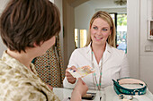 Young woman paying cashier in shop