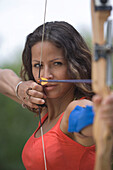 Young female archer drawing bow, Apulia, Italy