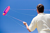 Man holding kite string, Apulia, Italy