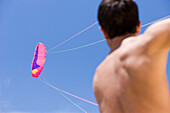 Young man holding kite string, Apulia, Italy