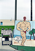 Mann macht Foto mit Bodybuilder-Attrappe, Venice Beach, Los Angeles, Kalifornien, USA