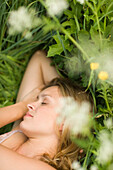 Young woman lying on meadow, close-up