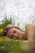 Young woman lying on meadow, close-up