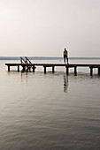 Young woman standing on jetty