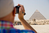 Tourist Filming Sphinx and Chephren Pyramid,Pyramids of Giza, Cairo, Eqypt