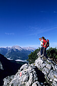 Two mountaineers on the Manndlgrat at Hoher Goell with a view to Watzmann and Hochkalter, Berchtesgaden Range, Upper Bavaria, Bavaria, Germany