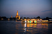 View over the river Menam Chao Phraya with a restaurant ship to Wat Arun, Temple of Dawn, Bangkok, Thailand