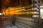 View along the golden Reclining Buddha, Wat Pho, The Temple of the Reclining Buddha, the largest and oldest wat in Bangkok, Bangkok, Thailand