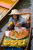 Woman in a wooden canoe at Floating Market, Damnoen Saduak, near Bangkok, Ratchaburi, Thailand