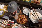 Woman offering food and souvenirs at Floating Market, Damnoen Saduak, near Bangkok, Ratchaburi, Thailand