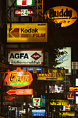 Illuminated signs along Th Khao San Road at night, Banglamphu, Bangkok, Thailand