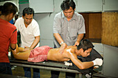 Thai Boxer getting a massage, Thai Boxing, Lumphini Stadium, Bangkok, Thailand
