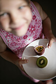 Girl with plate of fruit