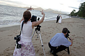 bride and groom, wedding, wedding photographer taking photos on Holloways Beach, nearby Cairns, Tropical North, Queensland, Australia